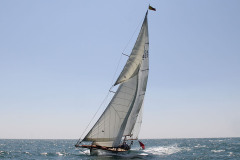 Beautiful wooden cruising yacht, sailing in the sunshine, flying Dart sails