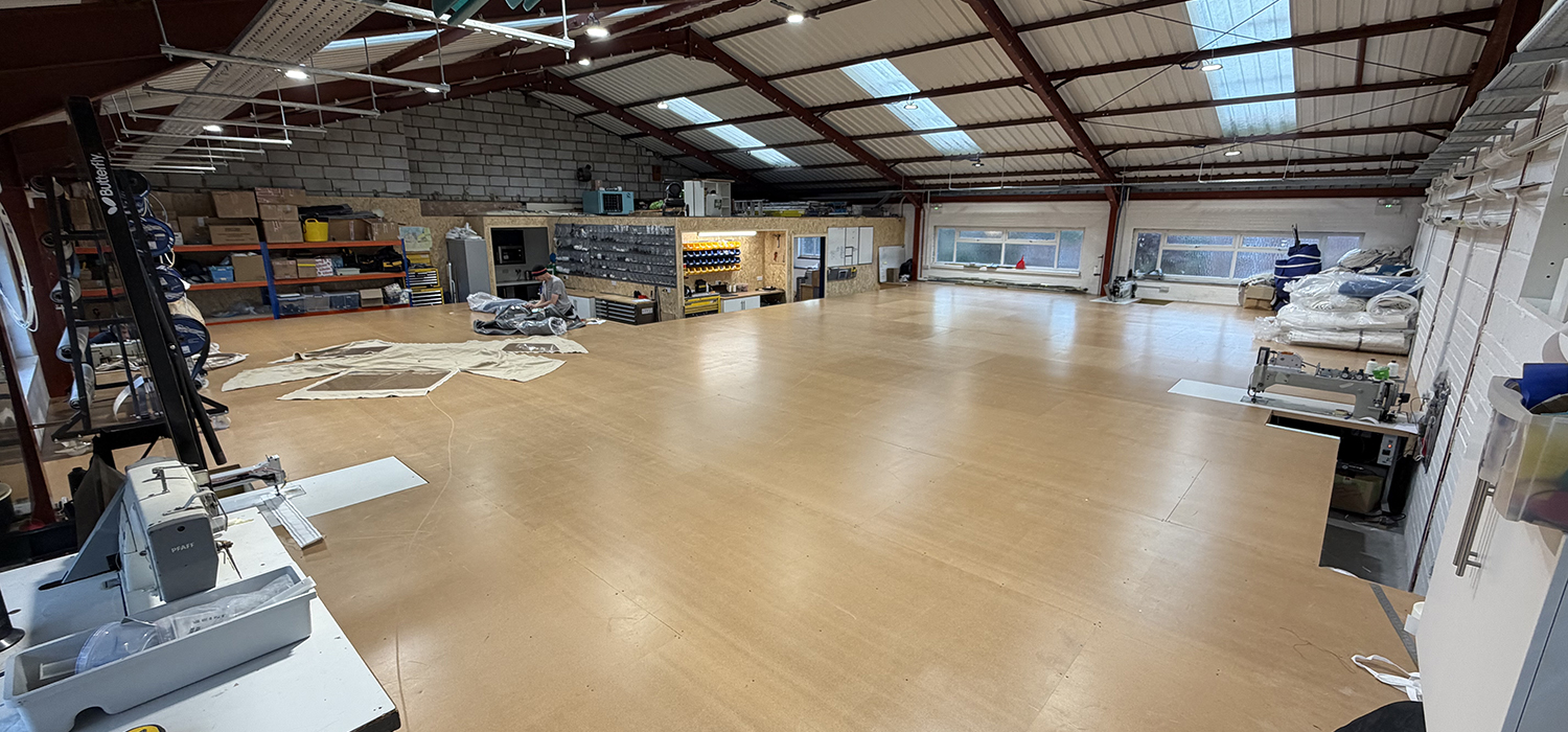 Dart Sails and Covers new Loft in Brixham Inside of new loft showing loft floor, machines and workstations in sail loft in Brixham