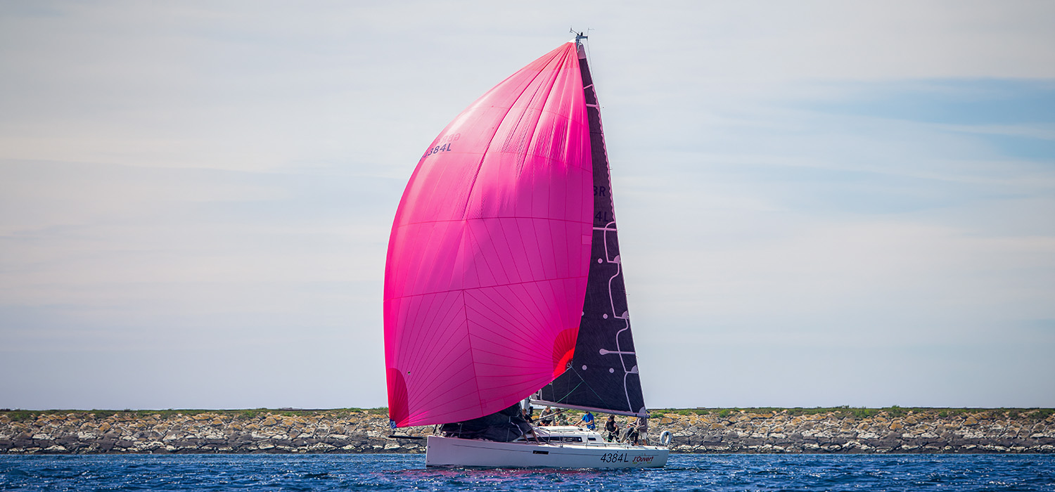 J112E J'Ouvert J112E J'Ouvert sailing downwind with a pink spinnaker. The yacht is flying Dart sails