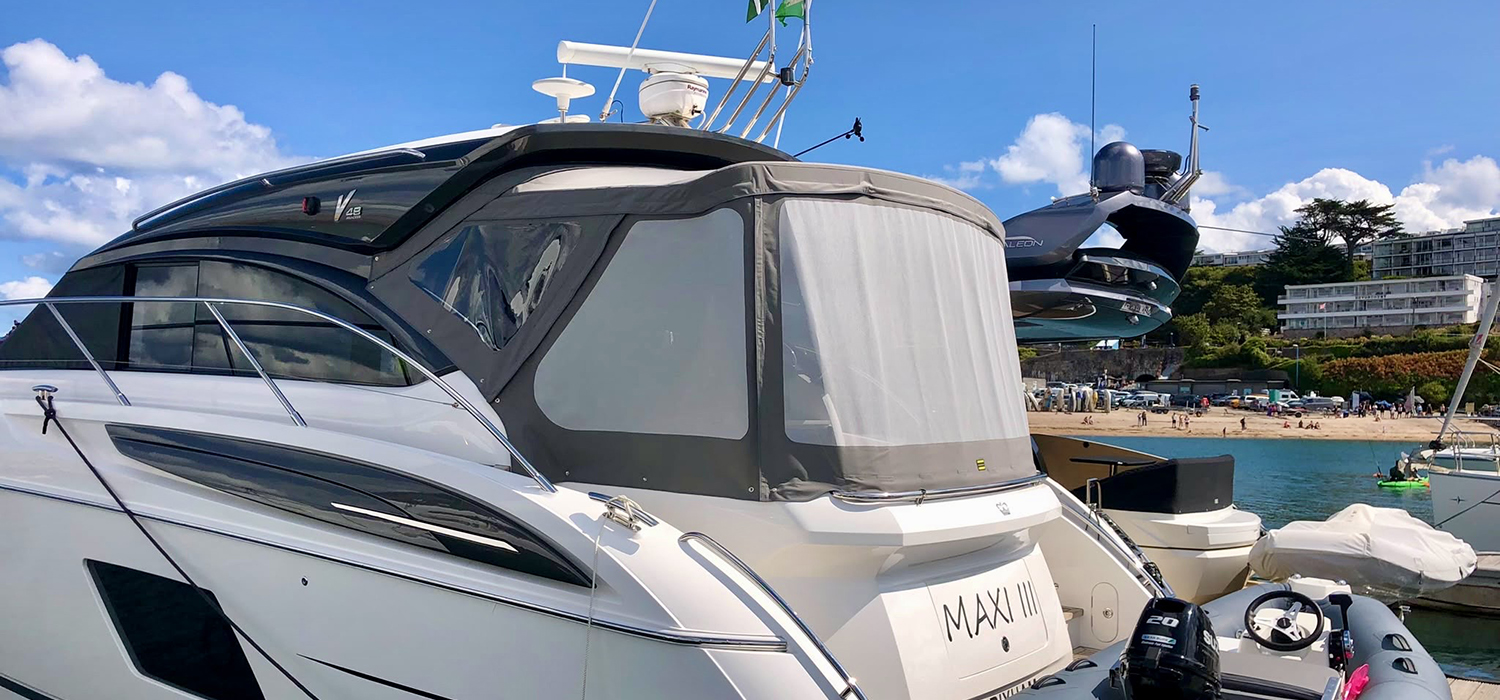 Boat Enclosure Motor boat in Brixham with new grey enclosure with mesh and windows, designed and custom built by Dart Sails and Covers