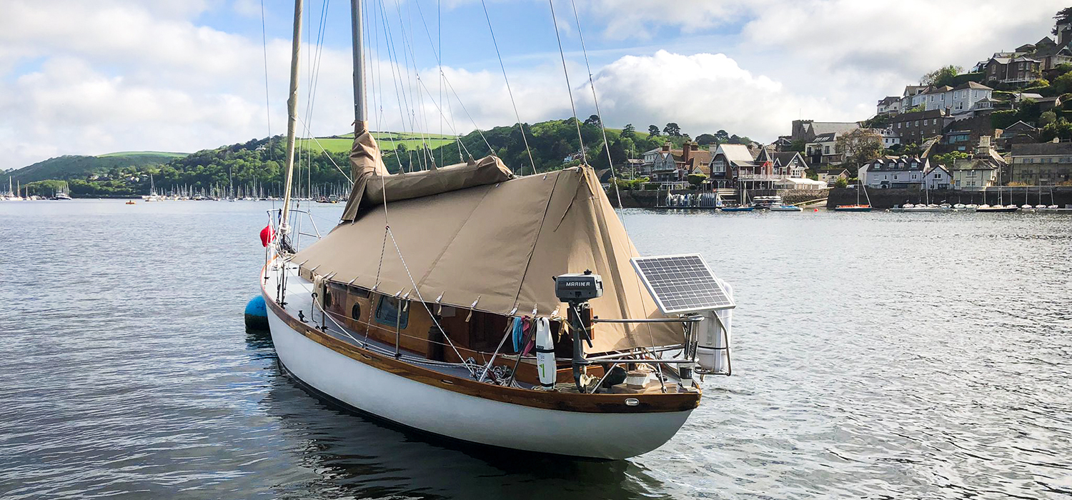Wooden yacht with covers and tent Wooden yacht with sail cover and boat cover/tent in beige on the River Dart, covers and canvas custom designed and made by Dart Sails and Covers