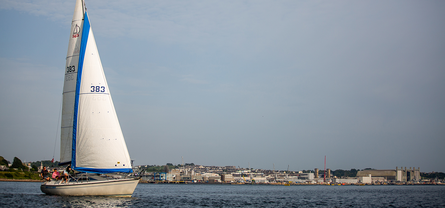 Dehler 34 Dehler 34 sailing upwind in small breeze, with furling Genoa with blue UV strips, made by Dart Sails