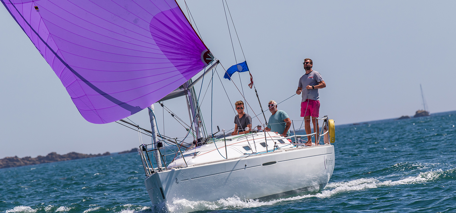 Moonfish sailing downwind Beneteau First 31.7 racing yacht Moonfish, racing downwind with a purple spinnaker made by Dart Sails