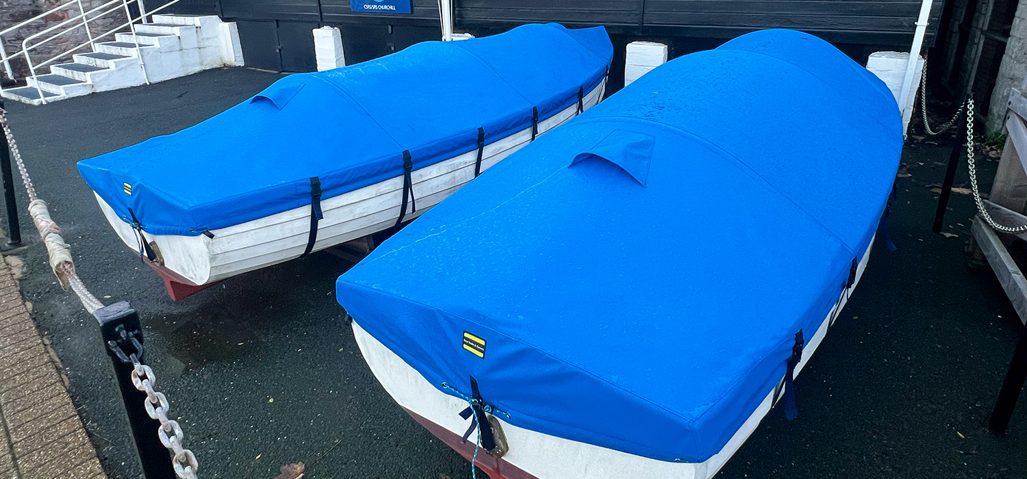 Blue boat covers Twin boat covers in blue, designed and made by Dart Sails and Covers with vents for the boats at Brixham Sea Rangers