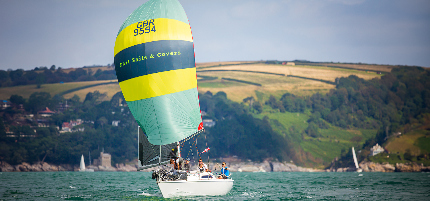 Impulsive sailing downwind Impulsive, an Impala 28, sailing downwind and racing, flying a Dart Sails and Covers branded spinnaker in yellow, grey and blue, designed and made by Dart Sails and Covers
